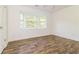 Bright bedroom with wood flooring and large window at 5880 Trent Walk Dr, Lithonia, GA 30038