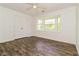 Bright bedroom with modern wood flooring, ceiling fan, and bay window at 5880 Trent Walk Dr, Lithonia, GA 30038