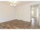 Bright dining room with wood flooring and elegant chandelier at 5880 Trent Walk Dr, Lithonia, GA 30038