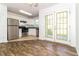 Modern kitchen with stainless steel appliances, granite countertops, and white cabinets at 5880 Trent Walk Dr, Lithonia, GA 30038