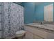 Bathroom with granite countertop, a toilet, and a shower curtain with blue butterfly pattern at 88 Oxford Ln, Kingston, GA 30145