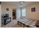 Cozy bedroom with ceiling fan, closet, and window, furnished with a TV stand and a bed with gray plaid covers at 88 Oxford Ln, Kingston, GA 30145