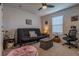 Cozy bedroom featuring neutral walls, large window, ceiling fan, and comfortable seating area at 88 Oxford Ln, Kingston, GA 30145