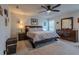 Main bedroom features a ceiling fan, window, neutral walls, and a complete furniture set at 88 Oxford Ln, Kingston, GA 30145