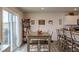 Dining room with gray wood flooring, modern table with six chairs, and access to a large sliding glass door at 88 Oxford Ln, Kingston, GA 30145