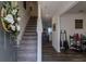 Inviting entryway featuring a staircase, modern flooring, and stylish decor at 88 Oxford Ln, Kingston, GA 30145