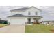 Charming two-story home features a well-manicured lawn, two-car garage and welcoming front porch with rocking chairs at 88 Oxford Ln, Kingston, GA 30145