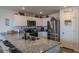 Open kitchen showcases stainless steel appliances, granite countertops, white cabinets, and modern fixtures at 88 Oxford Ln, Kingston, GA 30145