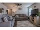 Comfortable living room with neutral color scheme, plush seating, ceiling fan, and a mounted television at 88 Oxford Ln, Kingston, GA 30145