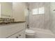 Bathroom featuring a granite countertop and a tiled shower and tub with a window at 2304 Ousley Ct, Decatur, GA 30032