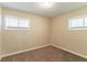 Carpeted bedroom featuring two windows with blinds and paneled walls at 2304 Ousley Ct, Decatur, GA 30032