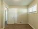 Carpeted bedroom with paneled walls featuring a window with blinds at 2304 Ousley Ct, Decatur, GA 30032