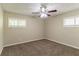 Neutral bedroom featuring two windows with blinds and a ceiling fan with lights at 2304 Ousley Ct, Decatur, GA 30032
