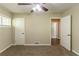 Neutral bedroom featuring carpet flooring, ceiling fan with lights, and white doors at 2304 Ousley Ct, Decatur, GA 30032