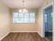 Cozy dining area with hardwood floors, chandelier lighting, and a large window providing natural light at 2304 Ousley Ct, Decatur, GA 30032