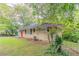 A pleasant view of a single-story home, showcasing the side yard and a glimpse of the front entrance at 2304 Ousley Ct, Decatur, GA 30032
