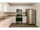 Updated kitchen with stainless steel appliances, granite countertops, and bright white cabinetry at 2304 Ousley Ct, Decatur, GA 30032