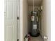 Utility room featuring a hot water heater and storage space at 2304 Ousley Ct, Decatur, GA 30032