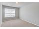 Bright bedroom with neutral carpet, a window providing natural light, and freshly painted walls at 2378 Morgan Creek Rd, Buford, GA 30519