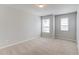 Bedroom with neutral carpet, two windows, and a closet at 2378 Morgan Creek Rd, Buford, GA 30519