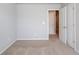 Carpeted bedroom with neutral walls showing an open closet and doorway at 2378 Morgan Creek Rd, Buford, GA 30519