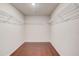 Walk-in closet featuring hardwood floors and wire shelving at 2378 Morgan Creek Rd, Buford, GA 30519