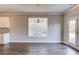 Dining room featuring hardwood floors, a chandelier, neutral paint, and windows overlooking backyard at 2378 Morgan Creek Rd, Buford, GA 30519