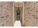 Front door in a recessed entryway with brick walls, a hanging light, and a 'welcome' mat at 2378 Morgan Creek Rd, Buford, GA 30519