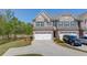 Two story brick townhome with a large driveway, two car garage, and well-manicured landscaping at 2378 Morgan Creek Rd, Buford, GA 30519