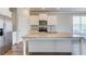 Kitchen featuring an island, stainless appliances, hardwood floors, granite countertops, and white cabinets at 2378 Morgan Creek Rd, Buford, GA 30519
