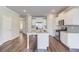 An open kitchen featuring an island with granite countertops, hardwood floors, and stainless steel appliances at 2378 Morgan Creek Rd, Buford, GA 30519