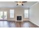 Living room featuring hardwood floors, neutral paint, a fireplace, large windows, and french doors at 2378 Morgan Creek Rd, Buford, GA 30519