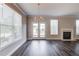 Bright living room featuring hardwood floors, a fireplace, neutral paint, and large windows at 2378 Morgan Creek Rd, Buford, GA 30519