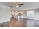 Open-concept living space showcasing a modern kitchen with an island and sleek wood flooring at 2378 Morgan Creek Rd, Buford, GA 30519