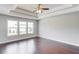Spacious main bedroom with tray ceilings, recessed lighting, and large windows at 2378 Morgan Creek Rd, Buford, GA 30519