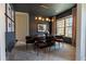 Elegant dining room featuring a modern chandelier, dark walls, and seating for six at 3482 Willow Meadow Ln, Douglasville, GA 30135