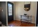 Well-lit entryway featuring hardwood floors, a modern console table, and an arched mirror at 3482 Willow Meadow Ln, Douglasville, GA 30135
