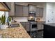 Stylish kitchen with stainless steel appliances, granite countertops and gray cabinets at 3482 Willow Meadow Ln, Douglasville, GA 30135