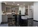 Well-equipped kitchen with stainless steel appliances, gray cabinets, sleek black countertops, and stylish black tile flooring at 3482 Willow Meadow Ln, Douglasville, GA 30135