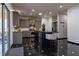 Well-equipped kitchen with stainless steel appliances, gray cabinets, sleek black countertops, and stylish black tile flooring at 3482 Willow Meadow Ln, Douglasville, GA 30135