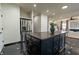 Modern kitchen island with black cabinets, stainless steel appliances, and stylish black tile flooring, great for entertaining at 3482 Willow Meadow Ln, Douglasville, GA 30135