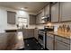 Charming kitchen with gray cabinets, stainless steel appliances, granite countertops, and dark tile flooring for easy maintenance at 3482 Willow Meadow Ln, Douglasville, GA 30135