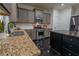 Beautiful kitchen with stainless steel appliances, granite countertops, and a black tiled floor at 3482 Willow Meadow Ln, Douglasville, GA 30135