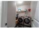 Well-equipped laundry room with modern washer and dryer on tile flooring, providing convenience and efficiency at 3482 Willow Meadow Ln, Douglasville, GA 30135
