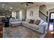 Cozy living room with comfortable gray sectional sofa, accent rug, and plenty of natural light for a warm, inviting space at 3482 Willow Meadow Ln, Douglasville, GA 30135