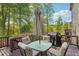 A cozy outdoor dining area on the back deck with wooded views, complete with table, umbrella and barbeque grill at 358 Nature Brook Se Walk, Smyrna, GA 30082