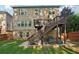 Exterior view of a two-story house with a wooden deck and stone patio in the backyard at 358 Nature Brook Se Walk, Smyrna, GA 30082