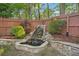 Landscaped backyard featuring a charming rock waterfall and lush greenery at 358 Nature Brook Se Walk, Smyrna, GA 30082
