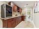 Elegant bar area featuring dark wood cabinetry, granite countertops, and a wine refrigerator at 358 Nature Brook Se Walk, Smyrna, GA 30082