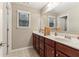 Bathroom with neutral walls and tile floor, double sinks and a large mirror at 358 Nature Brook Se Walk, Smyrna, GA 30082